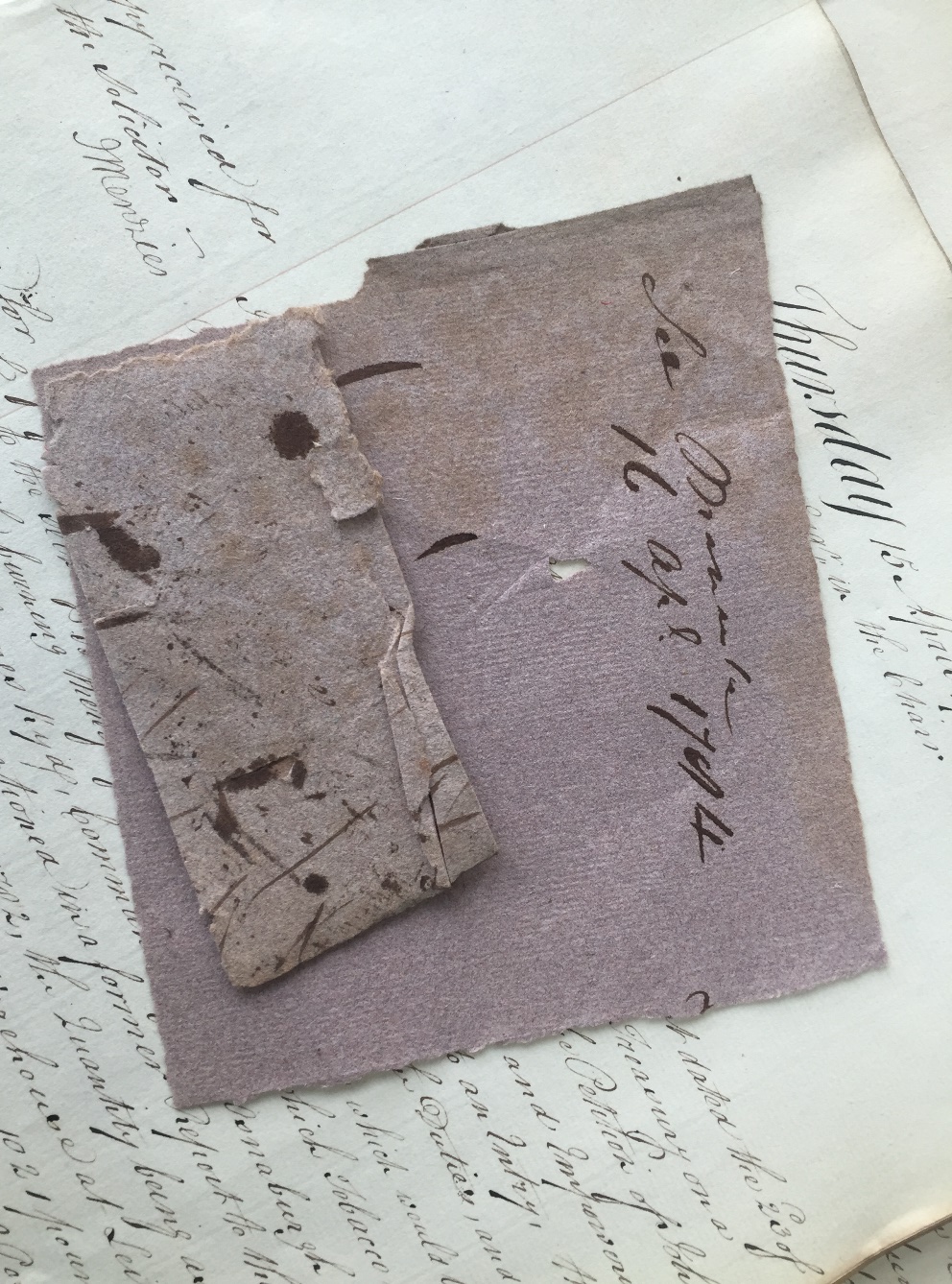 Brown blotting paper with ink stains shown against a manuscript.